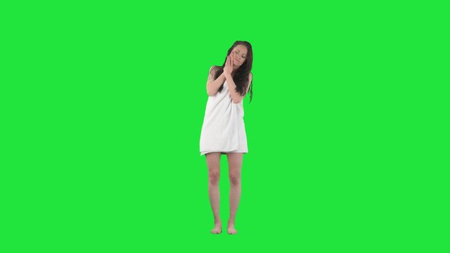 Young attractive woman suffering from toothache with painful expression touching jaw. Full body isolated on green screen background. 