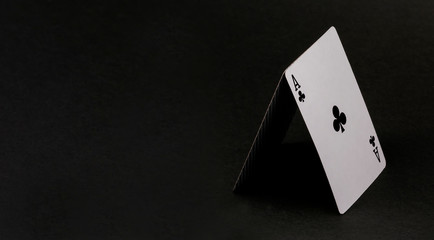 House of cards isolated on black. Ace cross on a black background