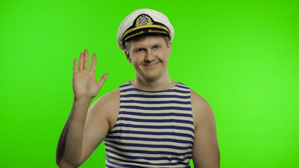 Fototapeta premium Young sailor man waving hand. Seaman guy in sailor's vest. Chroma key