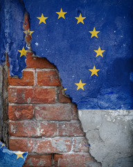 Eurozone problems. EU flag painted on the wall with which the plaster crumbles, revealing the old...
