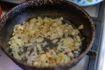 Sliced ​​onions fried in a pan