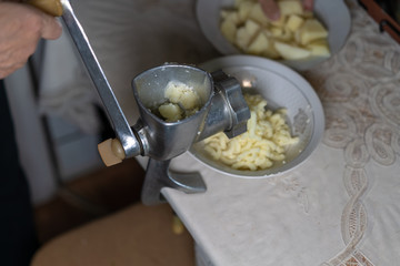 Manual meat grinder grinds vegetables