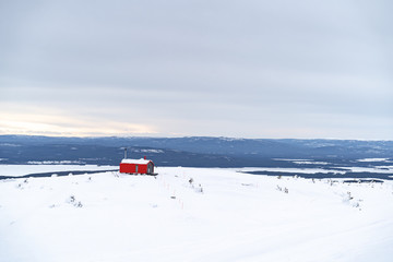 red house on top of a mountain in the Arctic circle