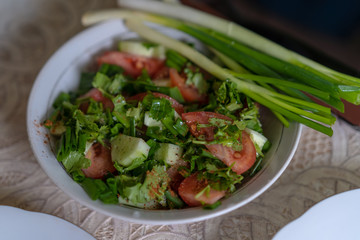 Fresh salad with tomatoes cucumbers and herbs