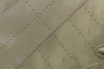 Old silver metal surface of the aircraft fuselage with rivets. Iron plate,steel sheet...