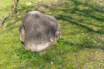 The stone lies on the grass