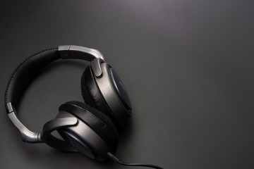 Fototapeta na wymiar Headphones wired on a black background