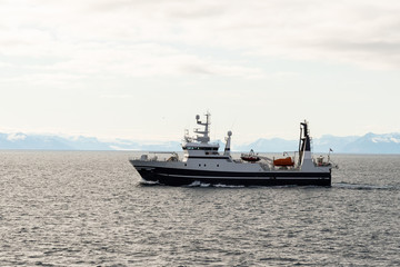 Obraz na płótnie Canvas Fishing boat in Arctic sea near Longyearbyen, Svalbard archipelago