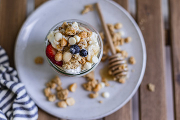 Healthy breakfast homemade granola with variety fruits and berries. Milk yogurt granola meal. Mental heath. Organic food. Vegetarian, vegan dietary. Organic meal. Food detox. Nutritional breakfast.