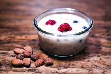 glass bowl with cereal and milk on rustic wooden table