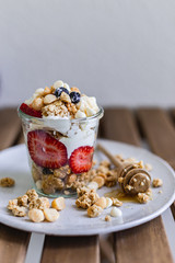 Healthy breakfast homemade granola with variety fruits and berries. Milk yogurt granola meal. Mental heath. Organic food. Vegetarian, vegan dietary. Organic meal. Food detox. Nutritional breakfast.