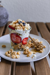 Healthy breakfast homemade granola with variety fruits and berries. Milk yogurt granola meal. Mental heath. Organic food. Vegetarian, vegan dietary. Organic meal. Food detox. Nutritional breakfast.