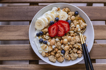 Healthy breakfast homemade granola with variety fruits and berries. Milk yogurt granola meal. Mental heath. Organic food. Vegetarian, vegan dietary. Organic meal. Food detox. Nutritional breakfast.