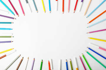 Frame of colored pencils on a white background. School concept, drawing lessons for children. Copy space, flat lay.