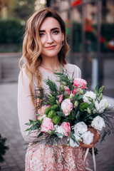 Girl with a bouquet of flowers outdoors