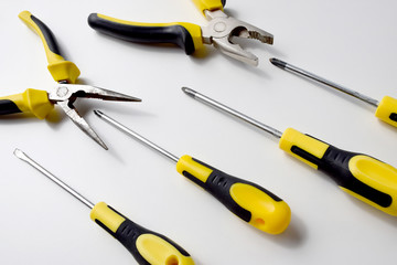 Kit set of black and yellow work instruments, pliers, wire cutters and screwdrivers for carpenter,...