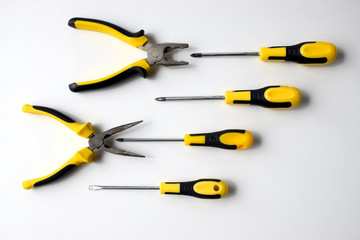 Black and yellow work tools, pliers, wire cutters and
screwdrivers which can be used to repair, build, improve, fix. Competition, fight, combat, battle, aggressive