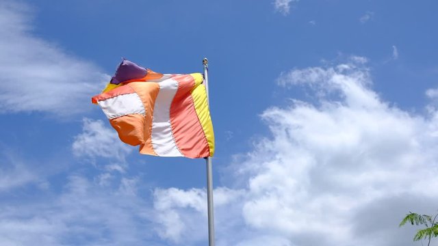 colorful buddhist flag waves in the wind Sri Lanka slow motion