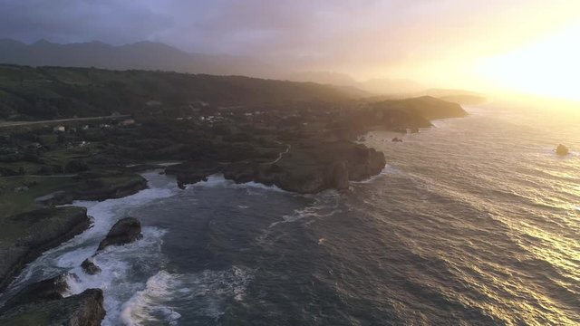 AERIAL DRONE SMOOTH FORWARD SHOT OF NORTHERN SPAIN CLIFF COAST AND SUNSET 