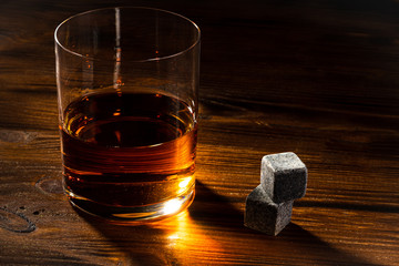 Glass of whiskey with stones. Selective focus