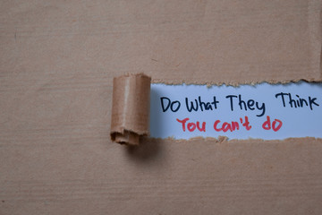 Do What They Think You Can't Do Text written in torn paper.