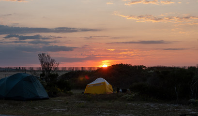 Tent camping near the ocean at sunrise.