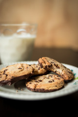 Chocolate cookies with milk glasses on a wooden surface  