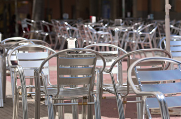 Image of outdoor terrace of a bar with empty chairs