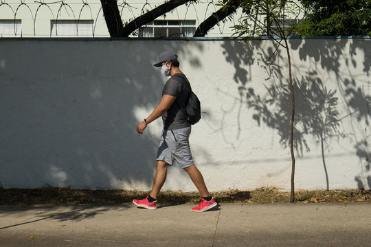 Man walks wearing face mask to protect himself from the virus in the pandemic.