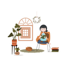 The girl is reading a book. Home interior, comfort. Home plants. Learning at home. 