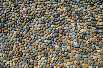 Pebble wall texture. Stone wall made of pebbles