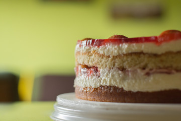 multi-layered cake with cream and strawberry fillings and gelatin-covered birthday cake