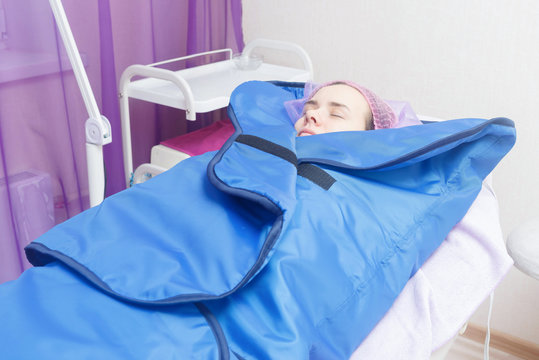 Young Woman Gets Thermal Blanket Treatment At Spa