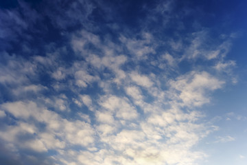 white fluffy cumulus clouds in the blue sky