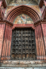 Fototapeta na wymiar A very old medieval weathered door to a church in Verona Italy