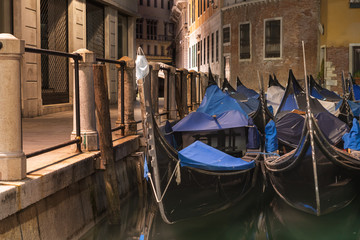 Fototapeta na wymiar gondolas docked on a tranquil canal in venice italy 