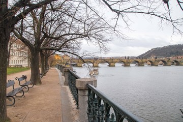 An empty path with trees next Vltava river in Prague