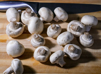 Table with fresh and organic mushrooms for cooking with knife