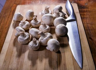 Table with organic mushrooms for cooking with knife