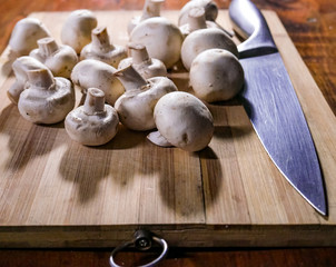 Table with fresh mushrooms for cooking with knife
