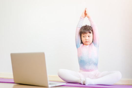 Video Streaming Stay Fit At Home.home Fitness Workout Class Live Streaming Online.Asian Kid Girl In Yoga Gymnastics Keep Calm And Fit.Online Class Live Videos On Laptop At Home.New Normal Healthcare.