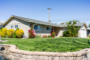 Exterior view of single-family detached home on a corner lot in a residential neighborhood; South San Francisco Bay Area, California