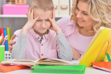 Mother with her son doing homework at home