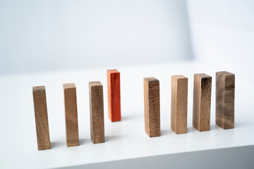Protection further infection of coronavirus covid-19 infection disease pandemic by social distancing working from home in self isolation quarantine, wooden domino block isolation apart from infected