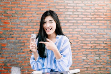 Asian businesswoman working from home live video interaction with customers using camera device...