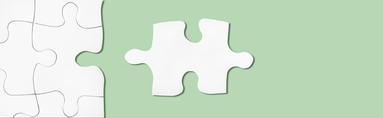 Puzzle on green surface. Connecting, network, synergy idea. Metaphor of teamwork, hr, problem...