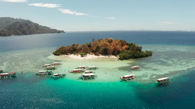 aerial view tropical island with sand white beach, clear and blue water. CYC Beach, Philippines, Palawan. Tropical landscape with blue lagoon, coral reef. travel concept