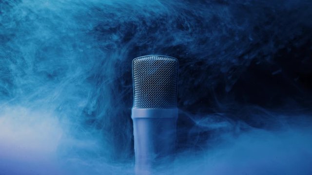 Microphone in blue liquid on a black background