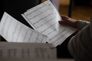 woman reading a music sheet