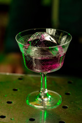 Close up of alcoholic cocktail, beverage, drink, prepared by professional barman in multicolored neon light. Entertainment, drinks, service concept. Modern bar, trendy neoned colors, copyspace.